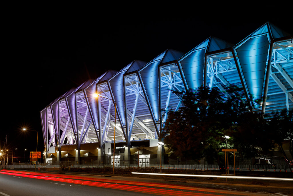 QLD Country Bank Stadium night time photograph. Low Angle with a long shutter speed. Roofing in UniCote Coastal, Off White