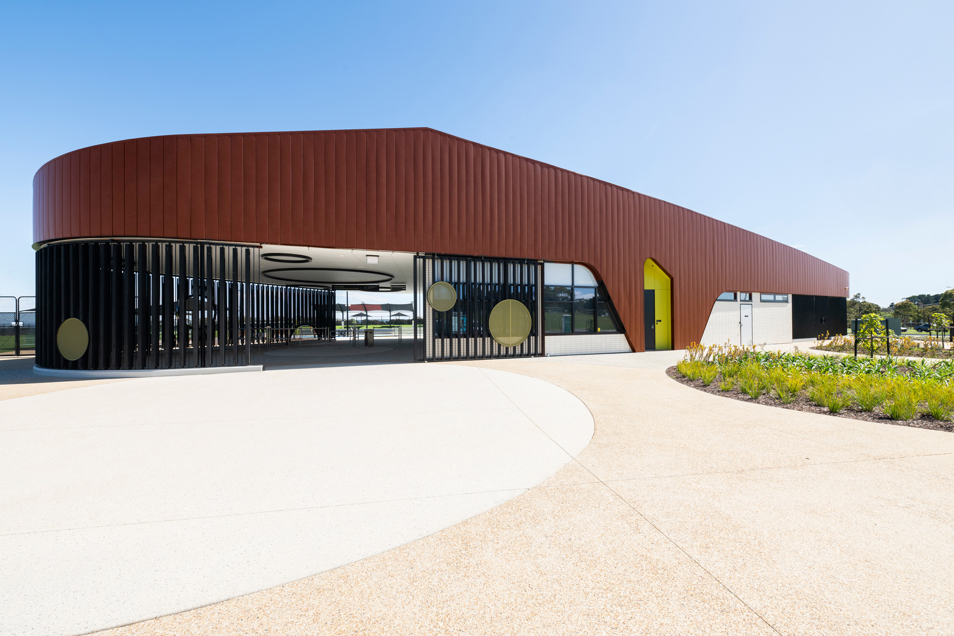 Modern poolside building at North Bellarine with Unicote Lux Corten Red exterior.